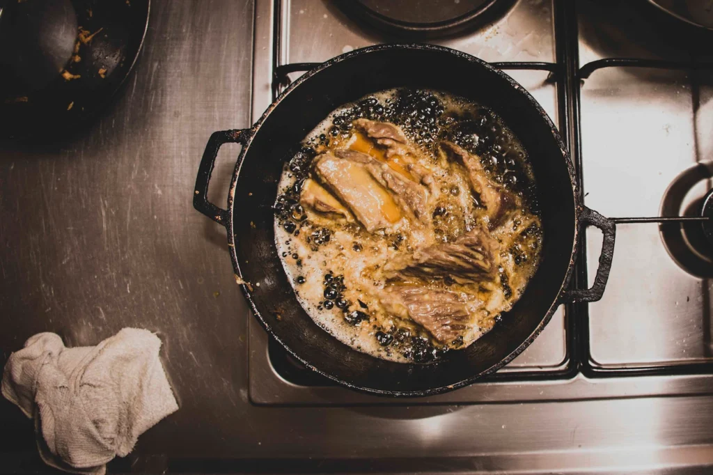Carne cocinándose en sartén de hierro, cocina de Gloria Inés — Sin Receta
